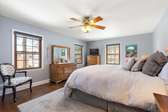 bedroom with dark hardwood / wood-style floors and ceiling fan