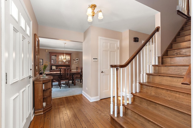 foyer featuring hardwood / wood-style floors and a notable chandelier