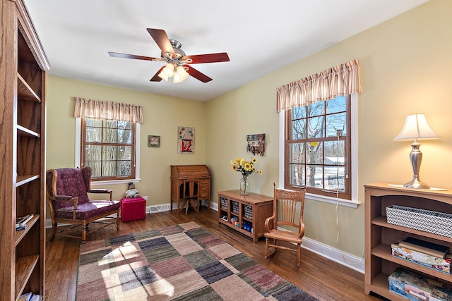 sitting room with ceiling fan and dark hardwood / wood-style floors