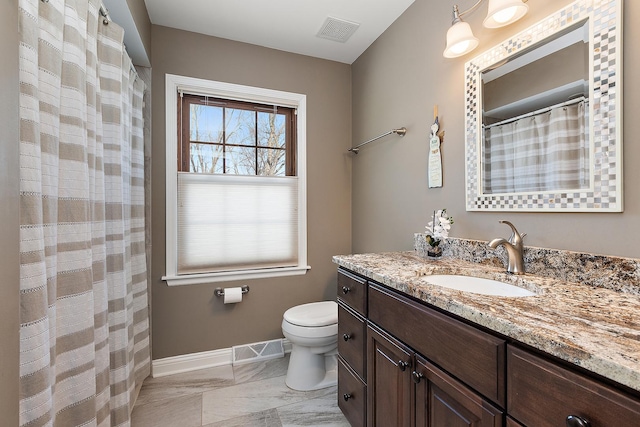 bathroom featuring toilet and vanity