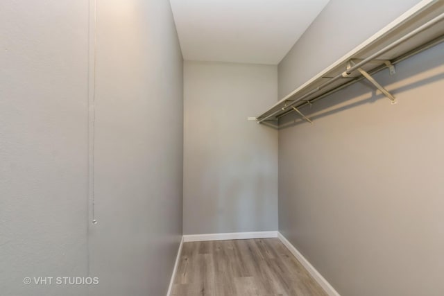 spacious closet with light hardwood / wood-style floors