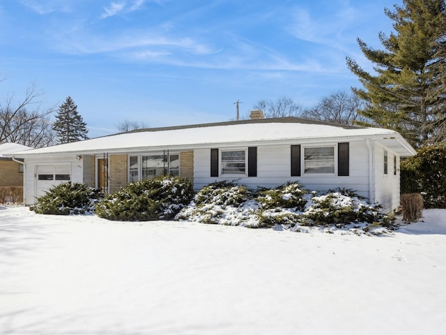 ranch-style home with a garage and brick siding