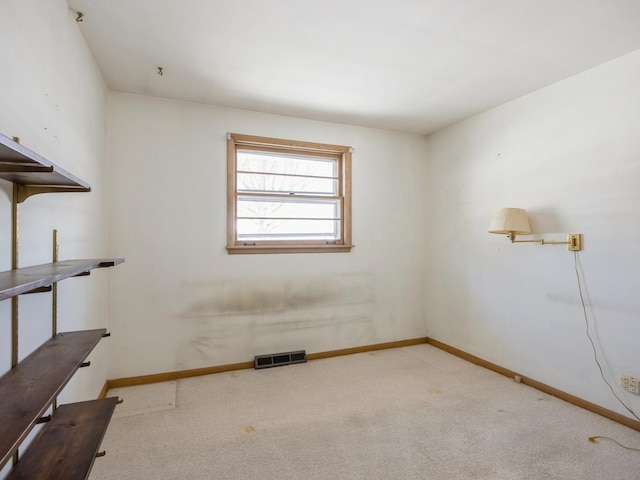 empty room with light carpet, visible vents, and baseboards