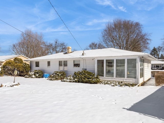 view of snow covered rear of property