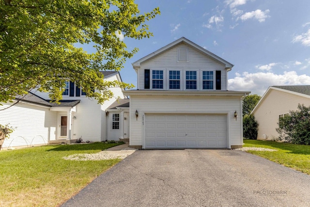 view of property with a garage and a front yard