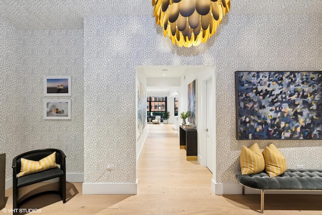 corridor with wallpapered walls and light wood-style floors