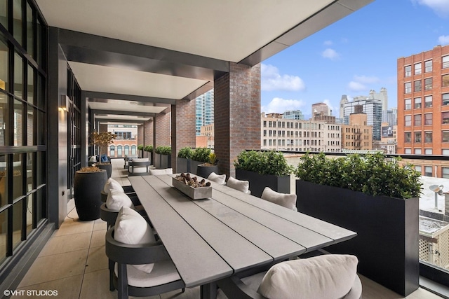 view of patio / terrace with outdoor dining area and a city view