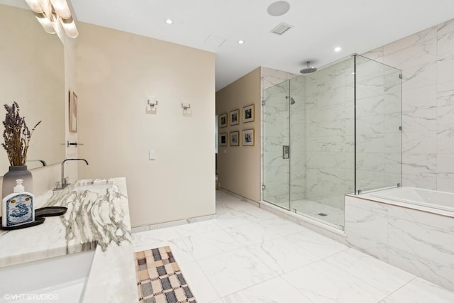 bathroom featuring a marble finish shower, marble finish floor, vanity, a bath, and recessed lighting