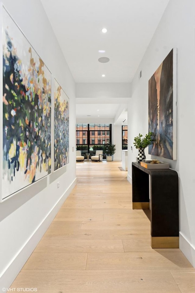 corridor with visible vents, baseboards, wood finished floors, and recessed lighting