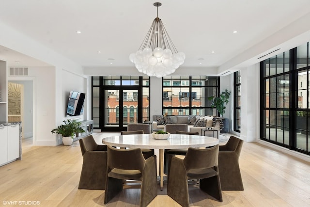 dining area with recessed lighting, visible vents, baseboards, light wood-style floors, and an inviting chandelier