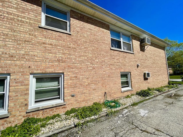 view of side of home featuring an AC wall unit