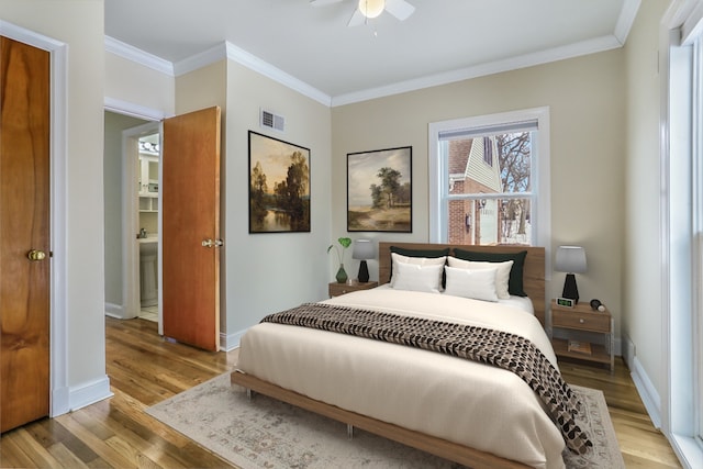 bedroom featuring light wood finished floors, visible vents, ornamental molding, a ceiling fan, and baseboards