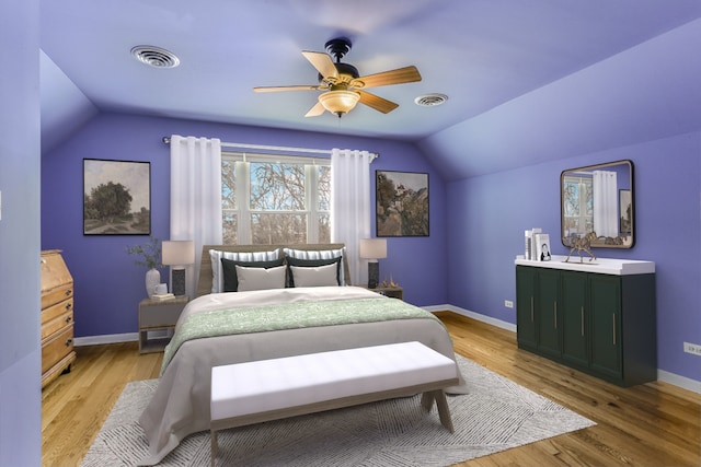 bedroom with lofted ceiling, baseboards, visible vents, and wood finished floors