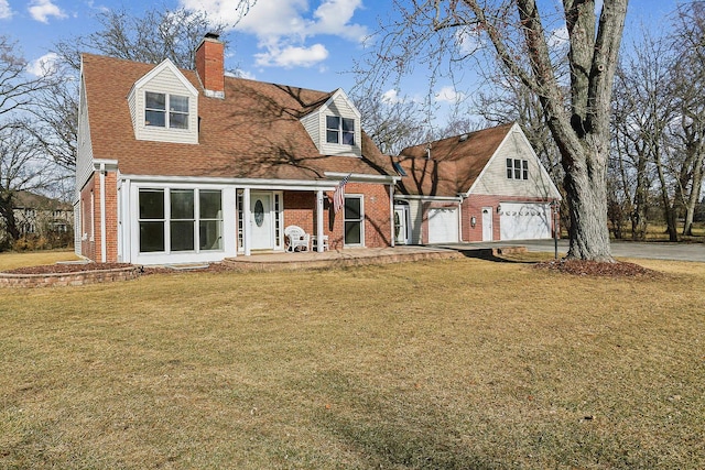 rear view of property featuring a garage, a chimney, a lawn, and brick siding