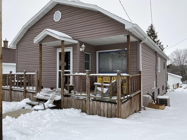 snow covered house with central AC