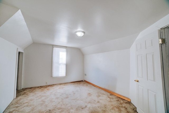 additional living space with carpet and vaulted ceiling