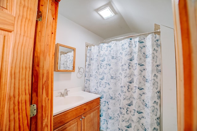 bathroom featuring curtained shower and vanity