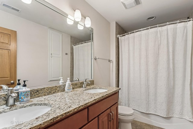 bathroom with vanity, tile patterned floors, and toilet