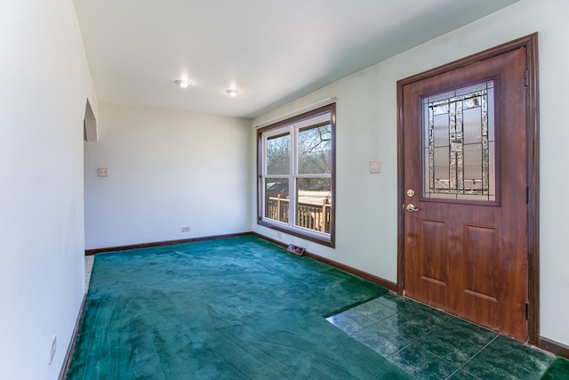 carpeted entrance foyer featuring tile patterned floors and baseboards