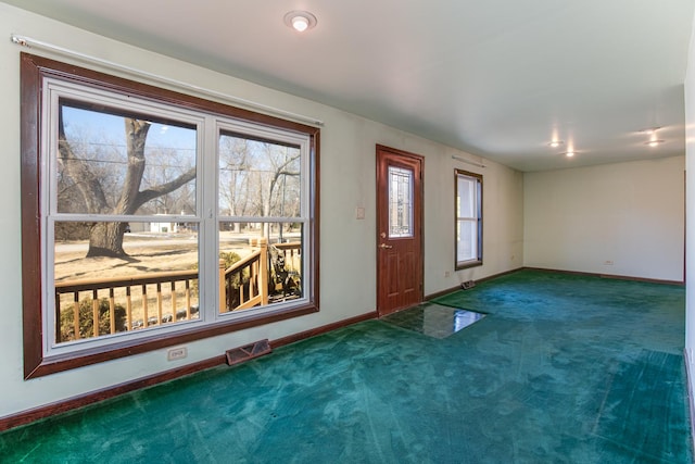 carpeted entrance foyer featuring visible vents and baseboards