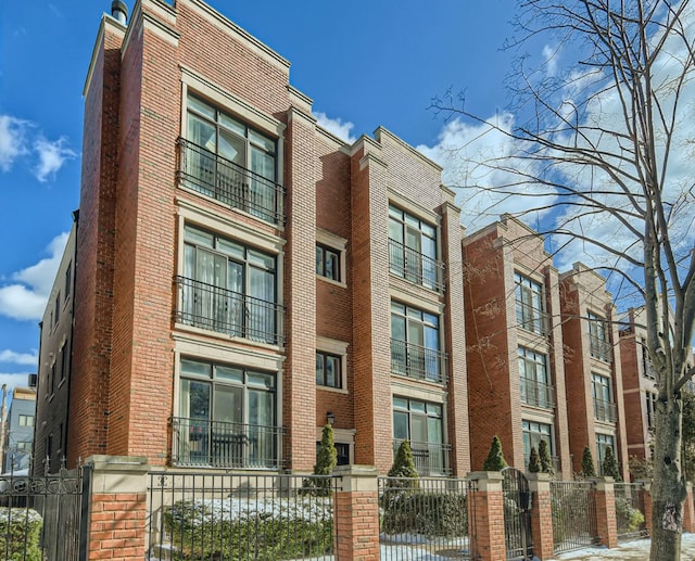 view of building exterior with a fenced front yard