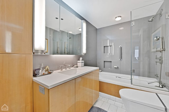 full bathroom with toilet, tasteful backsplash, bath / shower combo with glass door, tile walls, and vanity