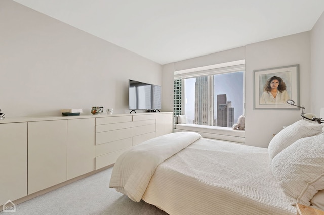 bedroom featuring light carpet