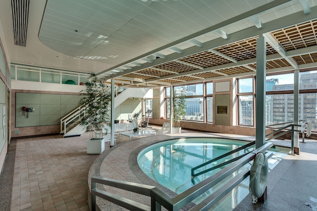 view of swimming pool featuring an indoor hot tub