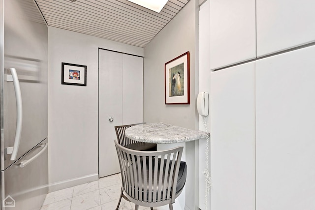 interior space featuring built in desk and wooden ceiling