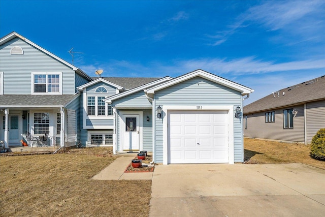 view of front facade with a garage, concrete driveway, and a front yard