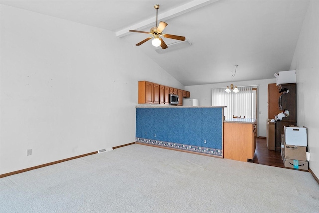 unfurnished living room with ceiling fan with notable chandelier, visible vents, baseboards, beamed ceiling, and dark carpet