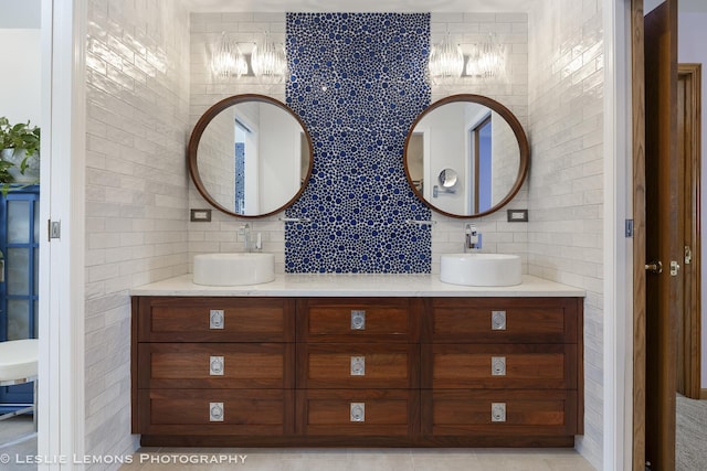 bathroom featuring tasteful backsplash, vanity, and tile walls