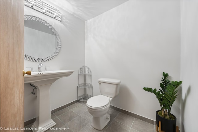 bathroom featuring tile patterned flooring, sink, and toilet