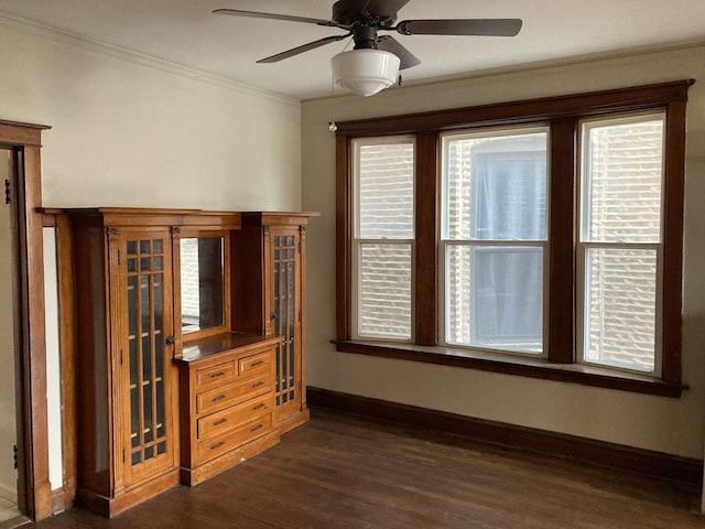 interior space with dark hardwood / wood-style flooring, crown molding, and ceiling fan