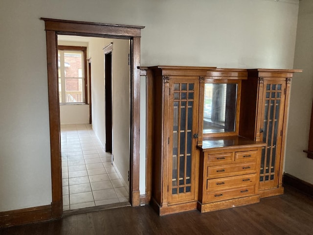 corridor with dark hardwood / wood-style flooring