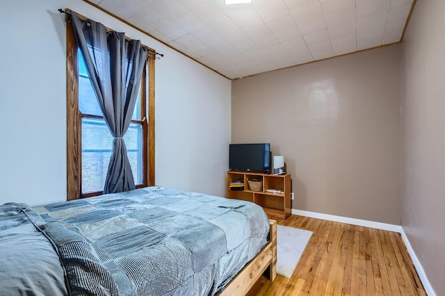 bedroom featuring hardwood / wood-style flooring and ornamental molding