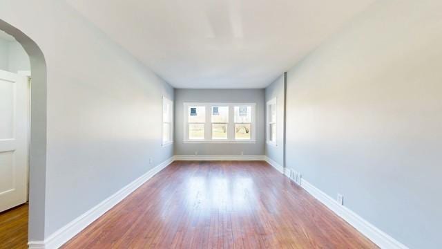 unfurnished room with wood-type flooring