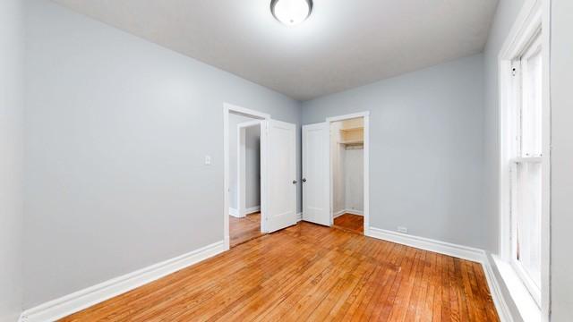 unfurnished bedroom featuring light hardwood / wood-style flooring and a closet