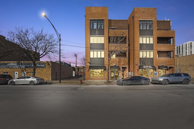 view of outdoor building at dusk