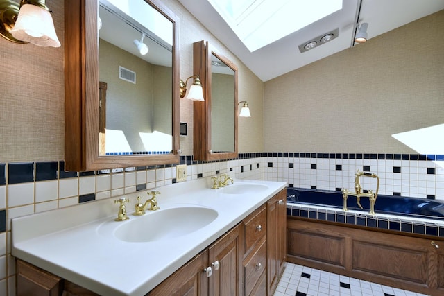 full bathroom featuring double vanity, lofted ceiling with skylight, a sink, and visible vents