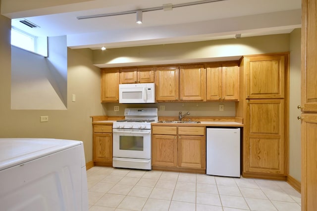 kitchen with white appliances, visible vents, washer / clothes dryer, light countertops, and a sink