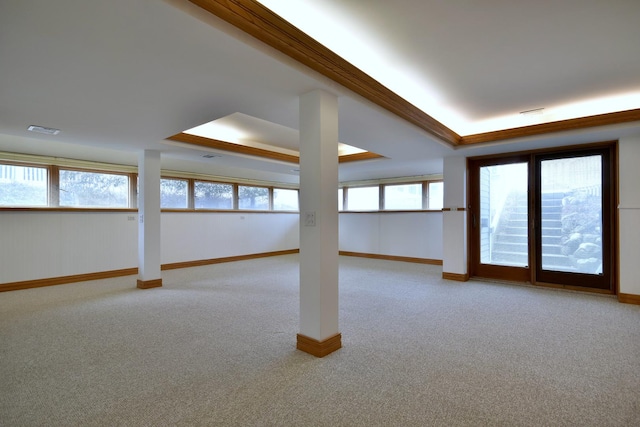 unfurnished room with light colored carpet, a raised ceiling, visible vents, and a healthy amount of sunlight