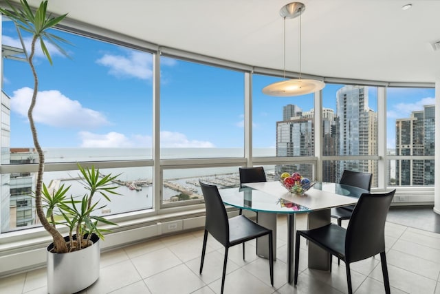 sunroom featuring a water view