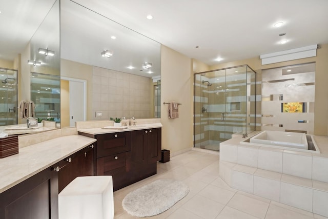 bathroom featuring vanity, shower with separate bathtub, and tile patterned floors