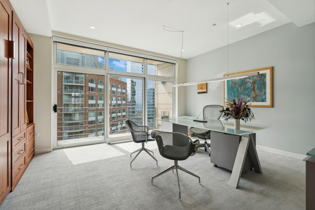 carpeted office space with floor to ceiling windows