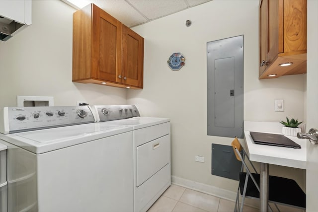 washroom with cabinets, light tile patterned floors, electric panel, and independent washer and dryer