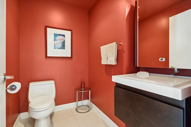 bathroom with vanity, tile patterned flooring, and toilet