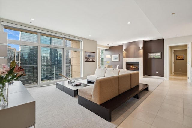 tiled living room featuring expansive windows and a tiled fireplace