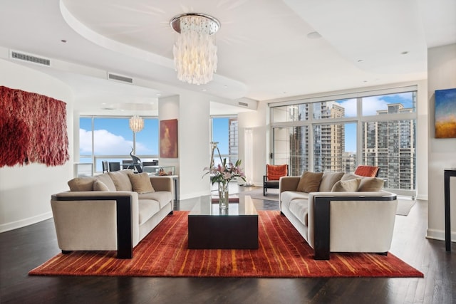 living room featuring dark hardwood / wood-style flooring and an inviting chandelier