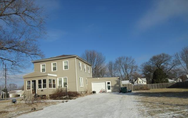 view of snow covered exterior featuring a garage